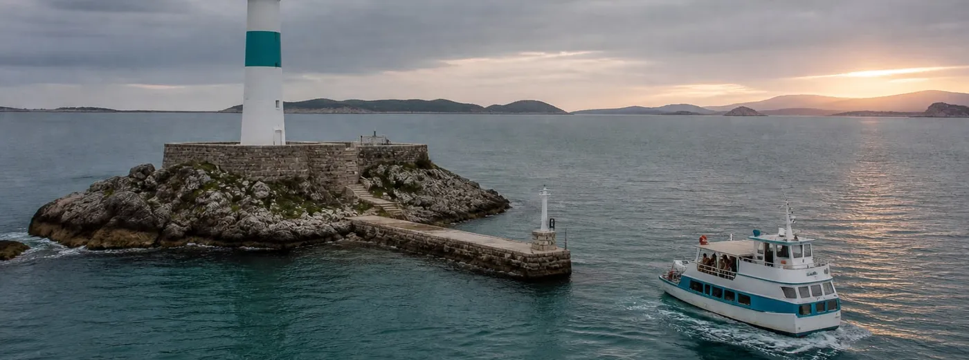 The Lighthouse Ferry approaching the small white lighthouse on the islet of Tirveth at the mouth of the bay, gulls overhead and the ring of islands on the horizon