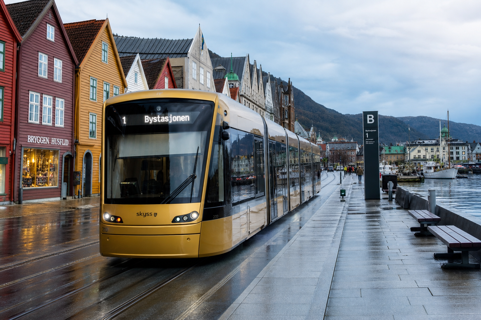 Amber modern low-floor tram on Strandgata coastal boulevard