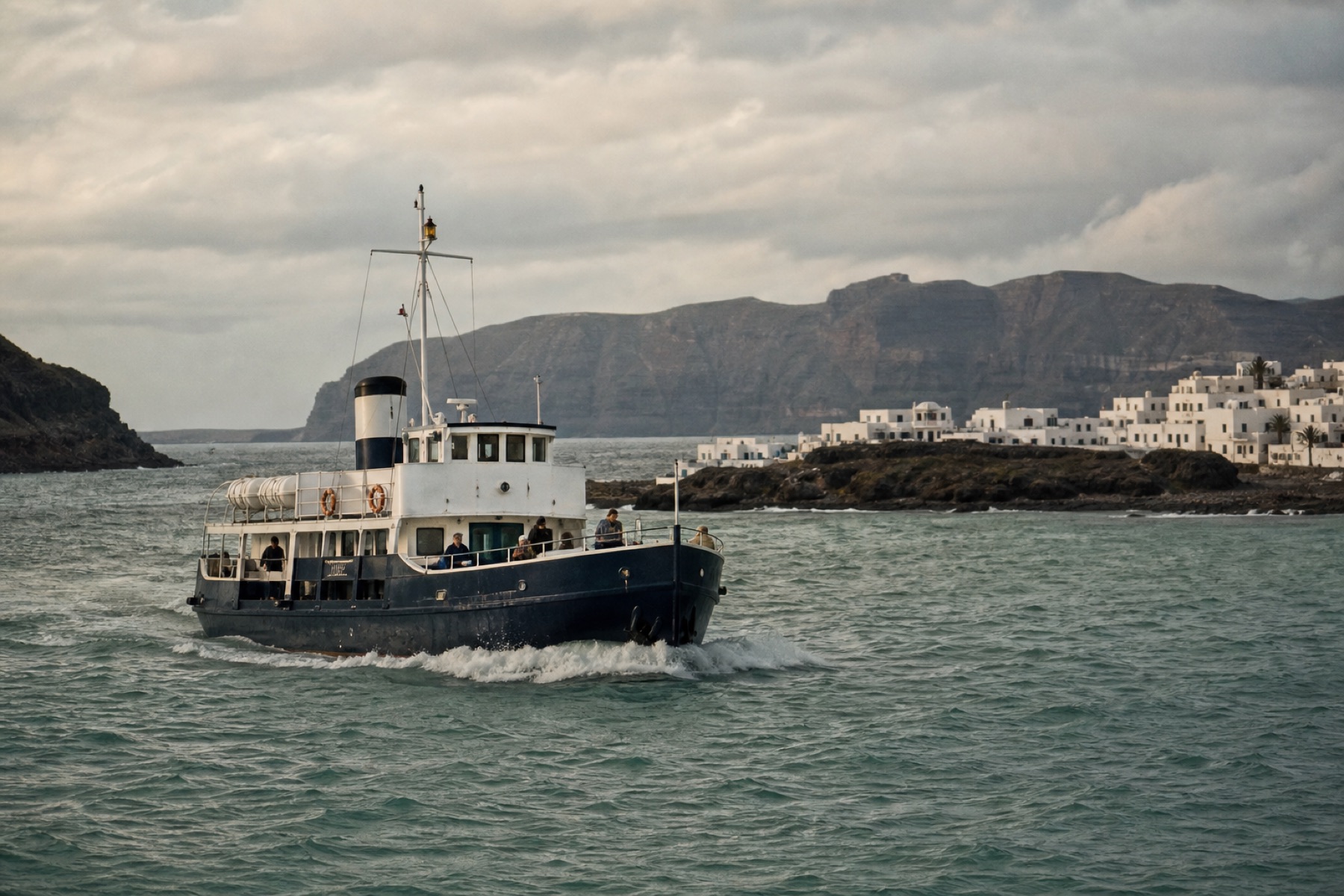 A navy municipal ferry crossing open water toward the harbour village on Nerith.